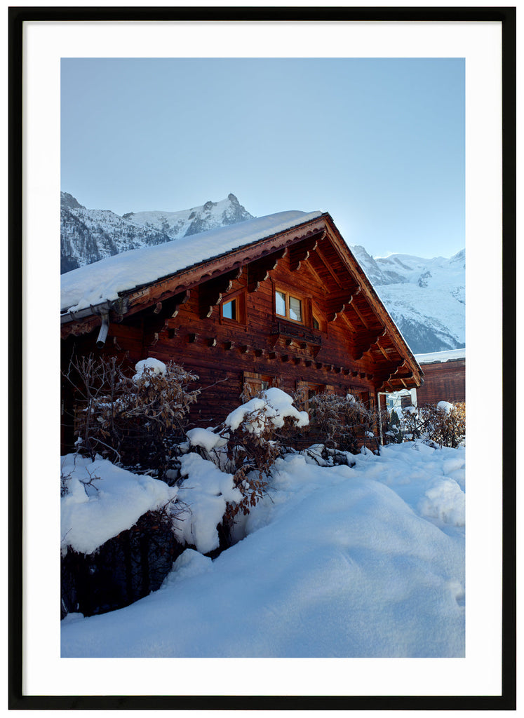 Red painted alpine cottage in Chamonix. Black frame. 