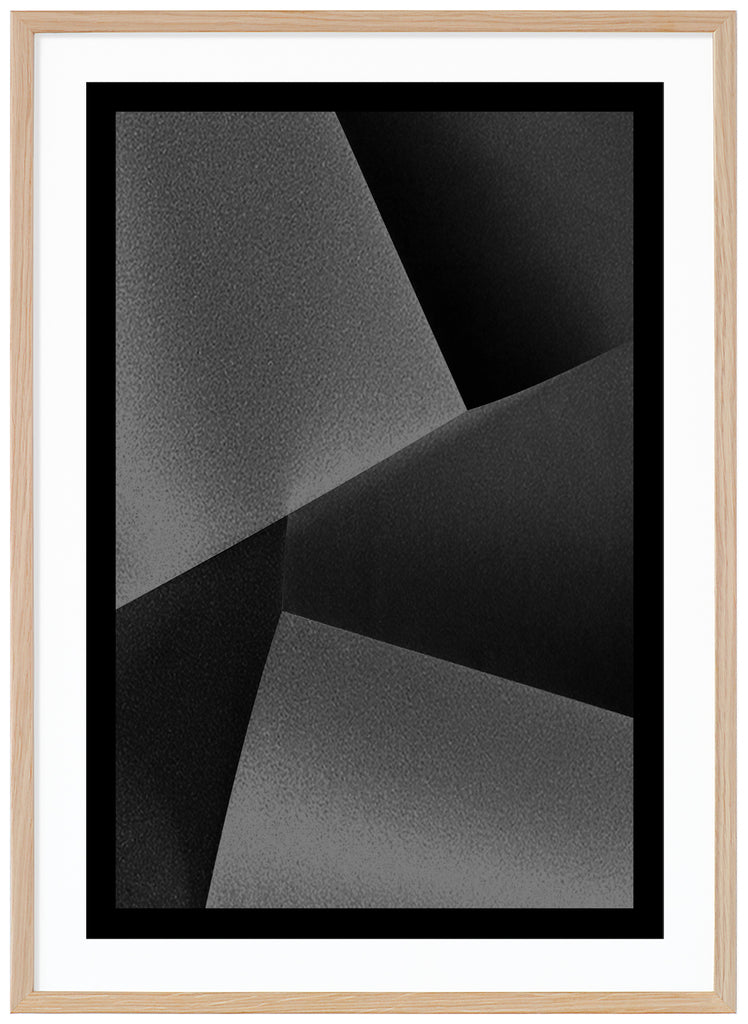 Black and white abstract and graphic items in different shades with a black border. Oak frame. 