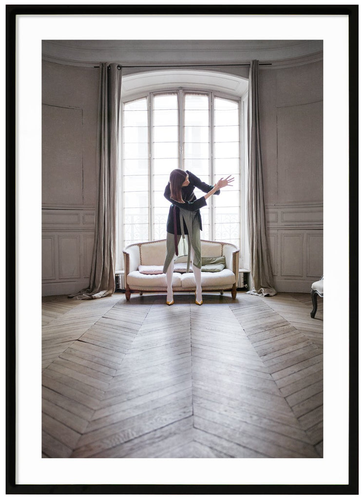 Woman photographed in front of a beautiful window in a Paris apartment. Black frame. 