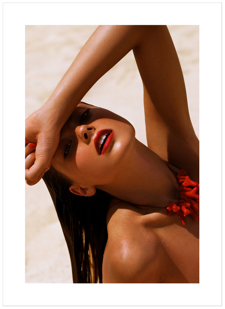 Photograph of a posed wet woman with red lips and top. 