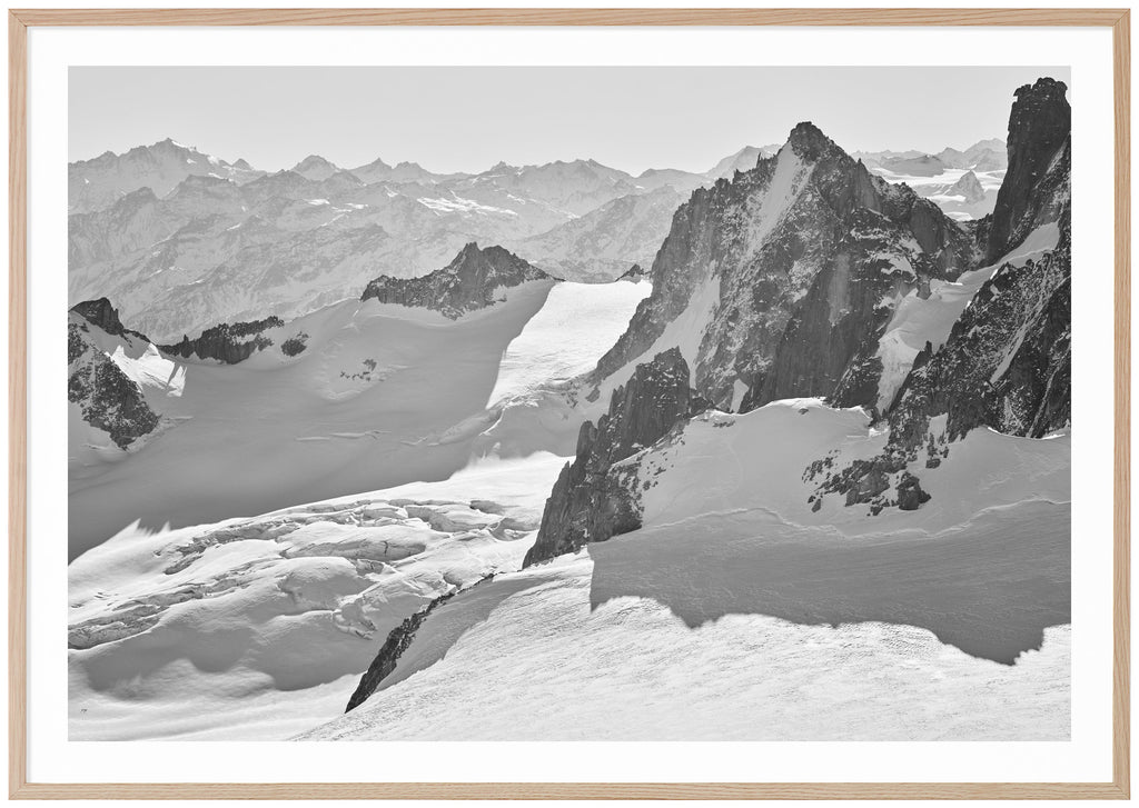 Magnificent view in the French Alps with snow-capped mountains and glaciers. Oak frame. 