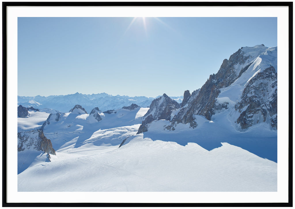 Color photography of snow-capped Alps in panorama. Black frame.