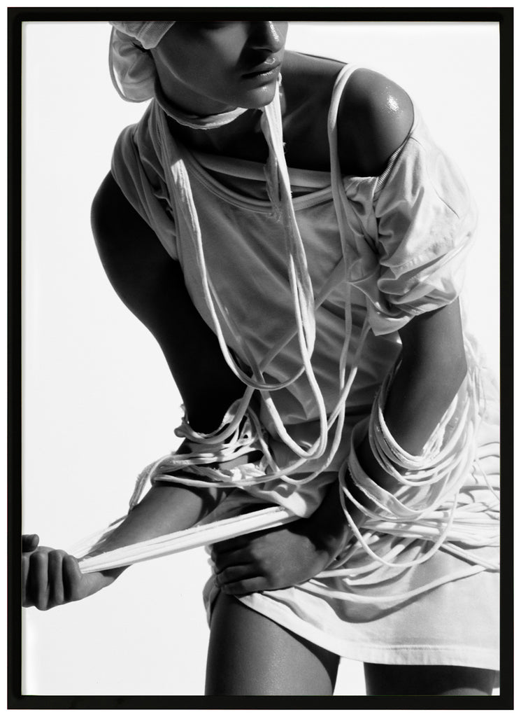 Black and white poster of woman with torn clothes. Black frame. 