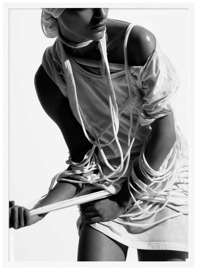 Black and white poster of woman with torn clothes. White frame.