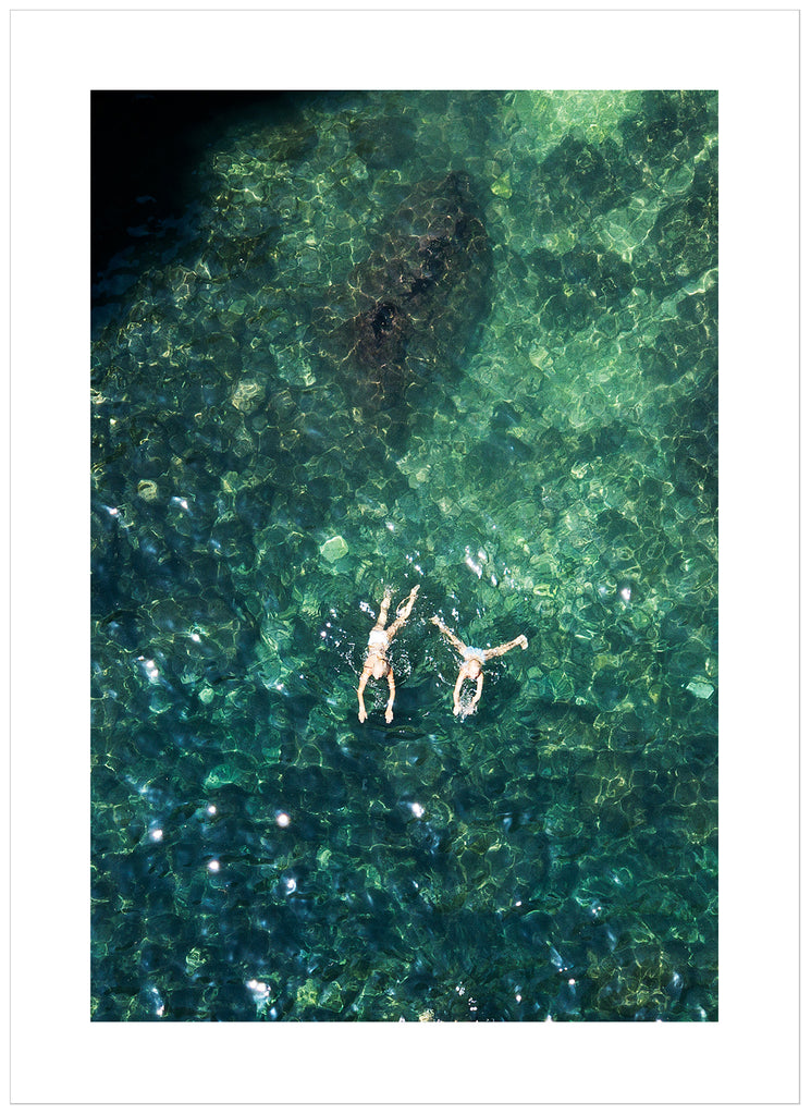 Records of two people swimming. Portrait format.