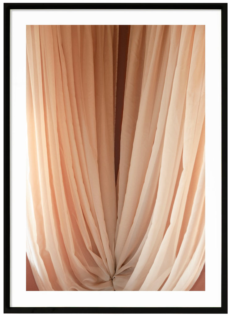 Color photography of curtains in beige tones. Black frame. 