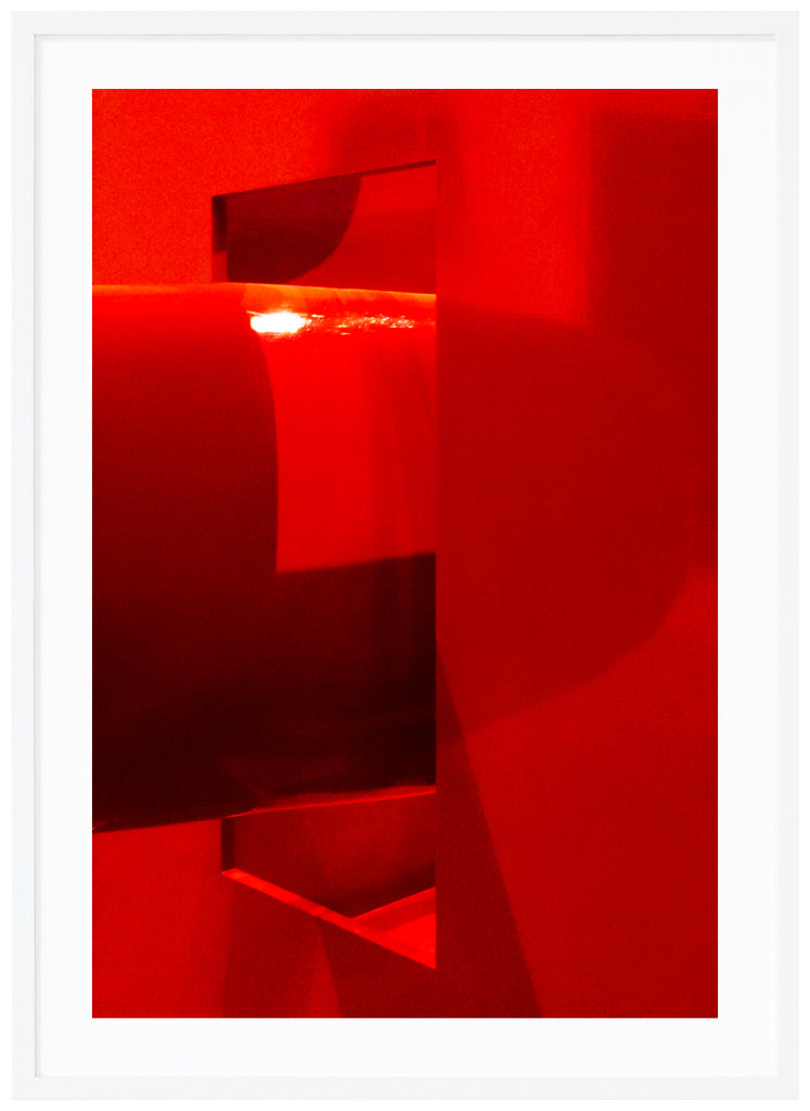 Red abstract print with a white surface around. White frame.
