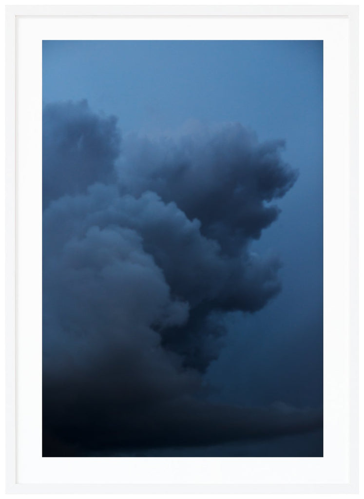 Photograph of dark clouds in the colors of dark blue. White frame.