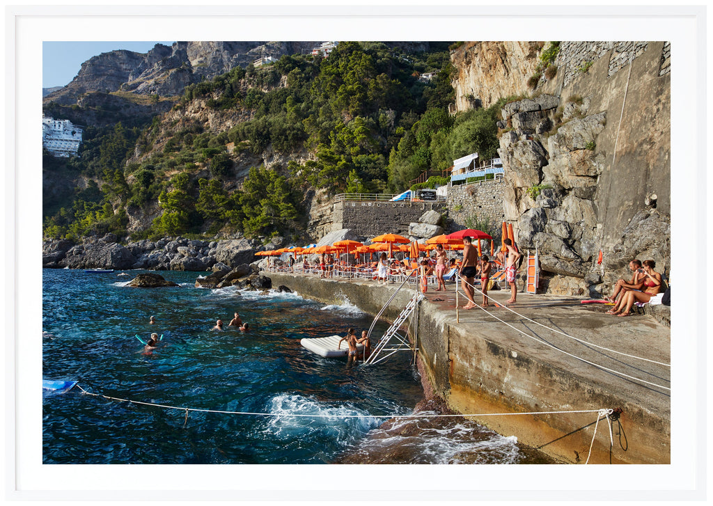 After a short boat ride from Positano, you arrive at One Fire Beach in Praiano. White frame.