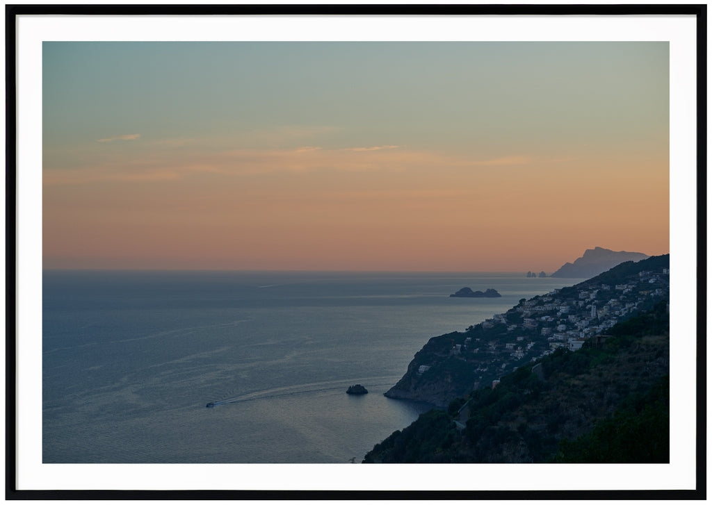View over water, mountains and boats. During sunset. Black frame. 