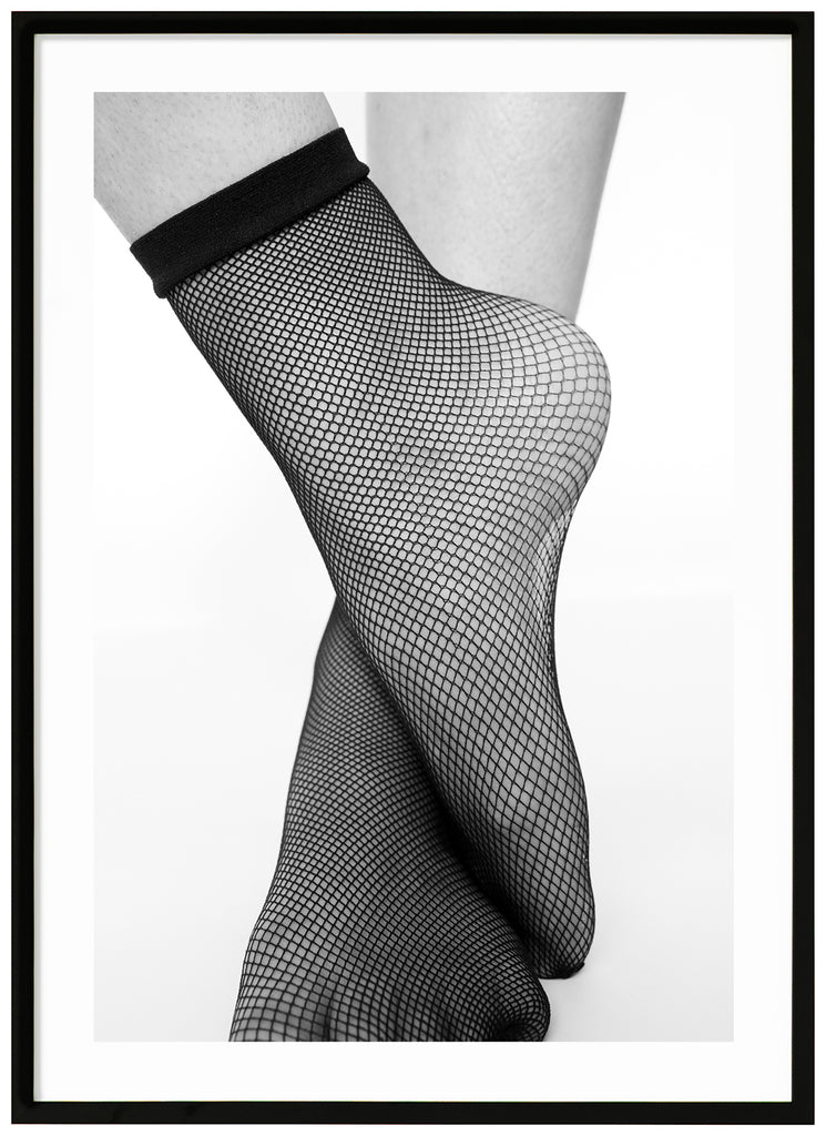 Black and white posters. Close-up of feet in fishnet stockings. Black frame. 