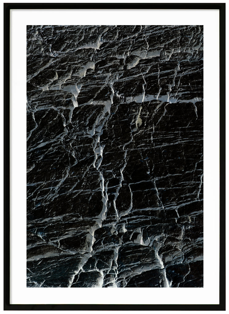 Black and white semi abstract poster with cracks. Black frame.