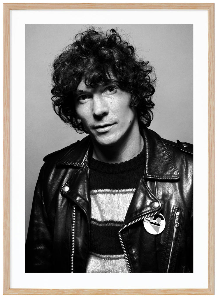 Photograph of Håkan Hellström wearing a black leather pie. Oak frame. 