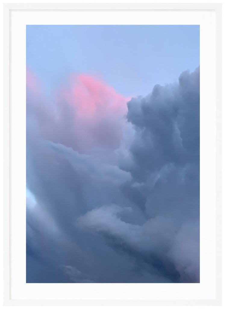 Poster of clouds in blue-gray tones and a light pink hue. White frame. 