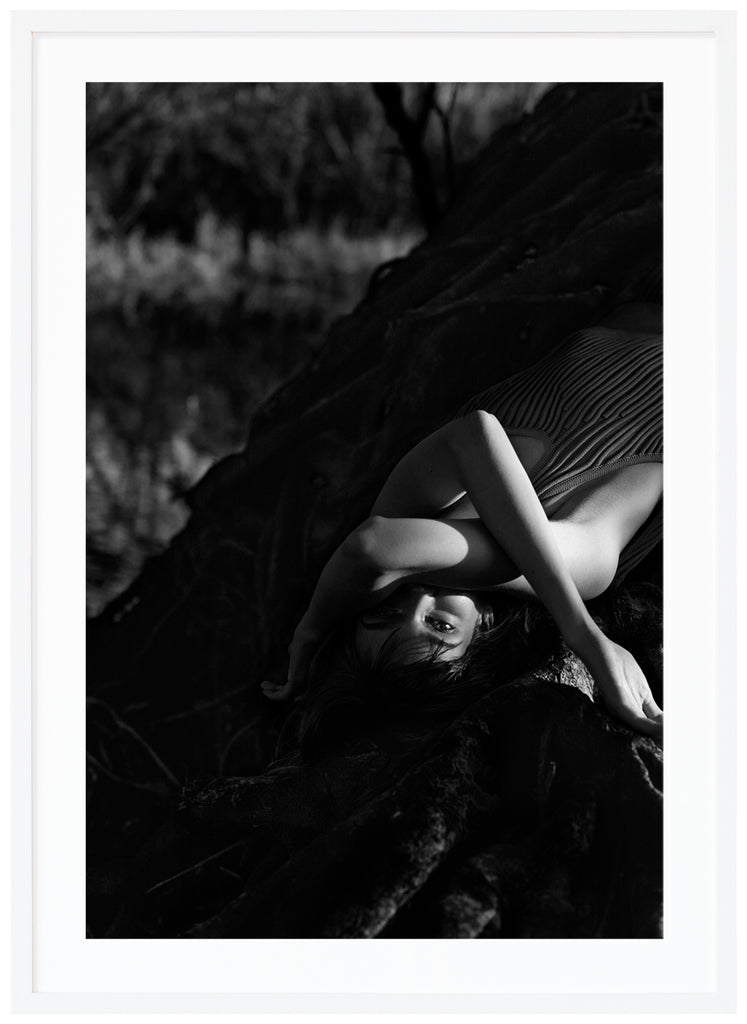 DreamsBlack and white poster of woman lying on a tree. White frame.