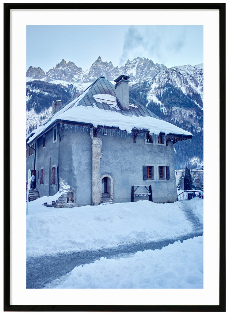 Old-fashioned stone house for ski school in the French Alps. Black frame.