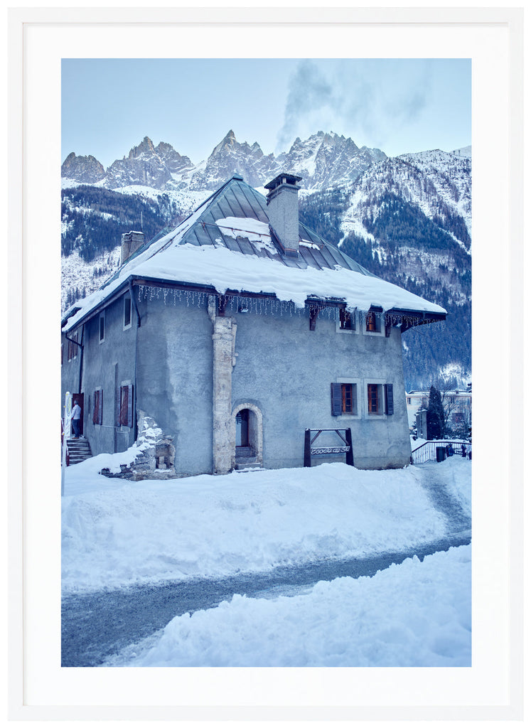 Old-fashioned stone house for ski school in the French Alps. White frame. 
