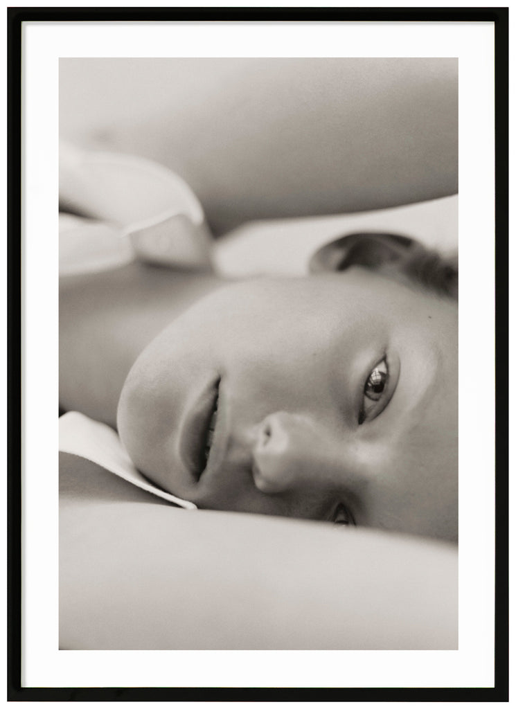 Black and white poster of close-up of woman. Standing. Black frame. 