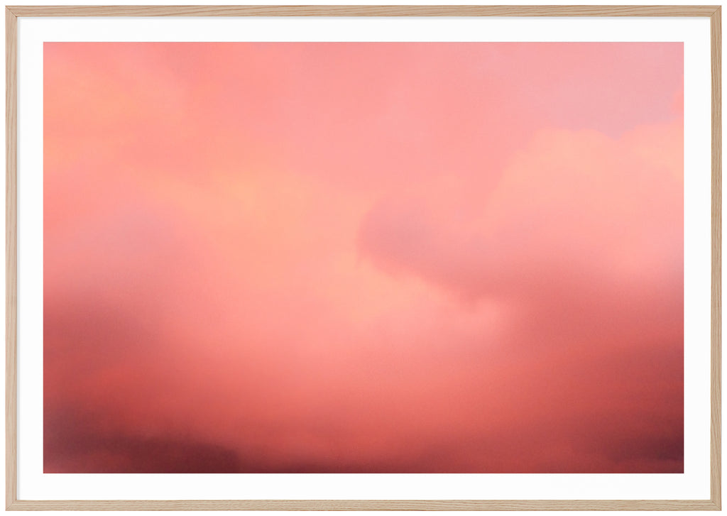 Poster of pink clouds in horizontal format.  Oak frame. 