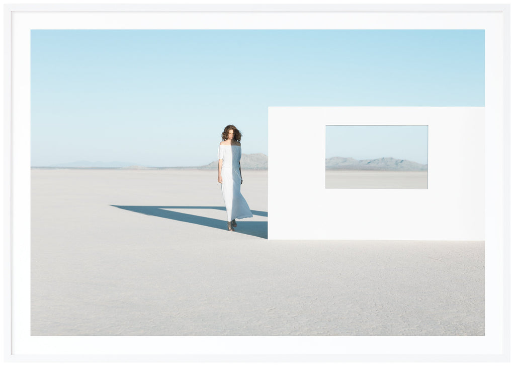 Photography of a woman in white dress in the Mojave Desert, California. White frame. 
