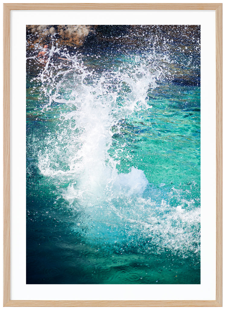Color photography on light blue water hitting the rocks in the background. Oak frame. 