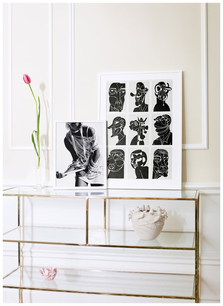 Black and white posters of nine different semi-abstract portraits. White frame. 