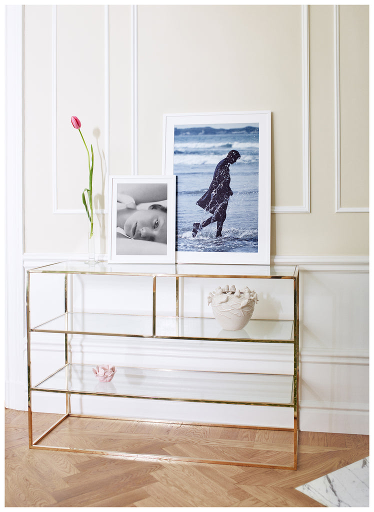 Poster of man in coat walking in the sea. Portrait format. White frame. 