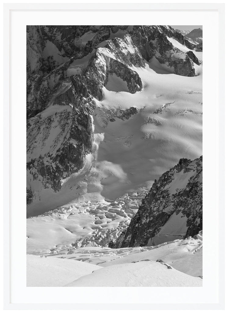black and white items of sun-drenched snow cover over the mountains of the Alps. White frame. 