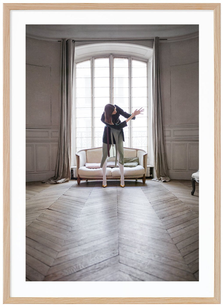 Woman photographed in front of a beautiful window in a Paris apartment. Oak frame. 