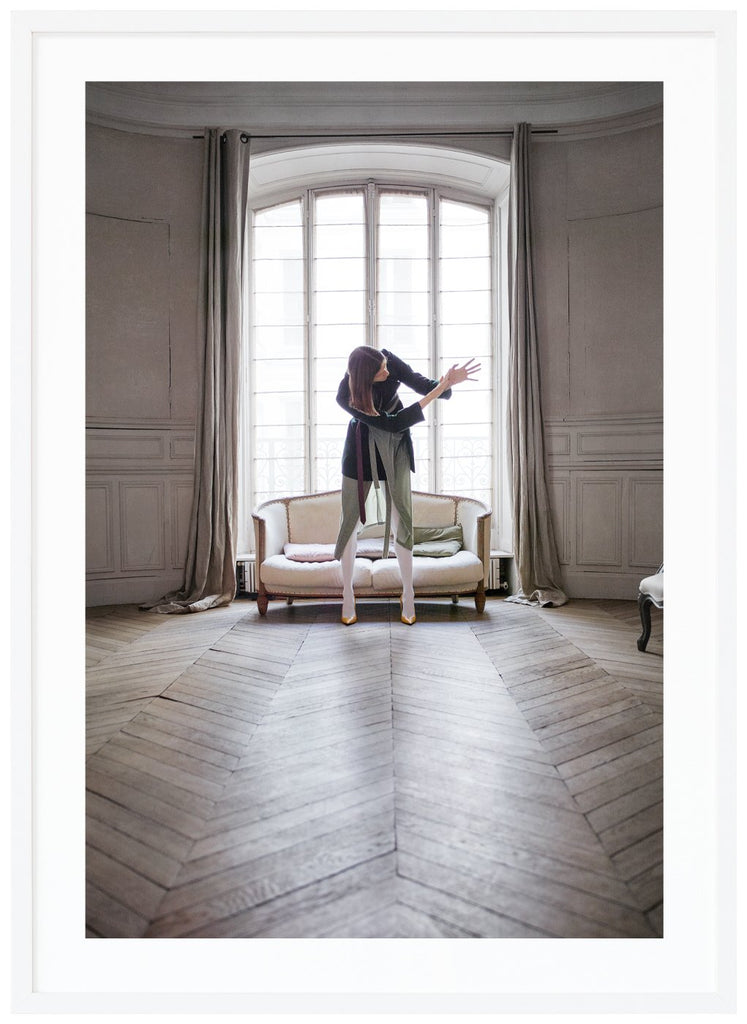 Woman photographed in front of a beautiful window in a Paris apartment. White frame. 