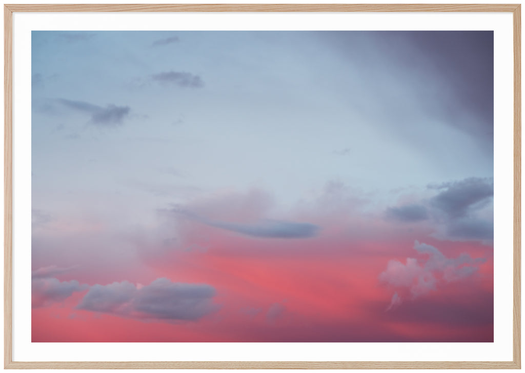 Photograph of clouds in red and blue light. Oak frame. 