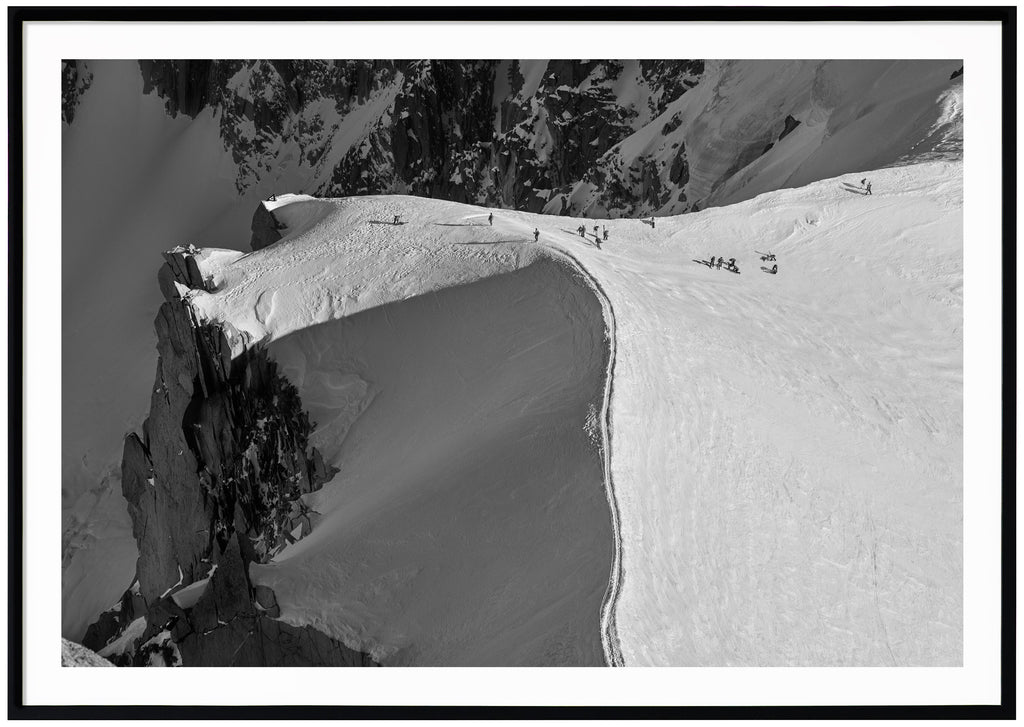 Bird's eye view of the snow-capped ridge at the Aiguille du Midi in Chamonix. Black frame. 