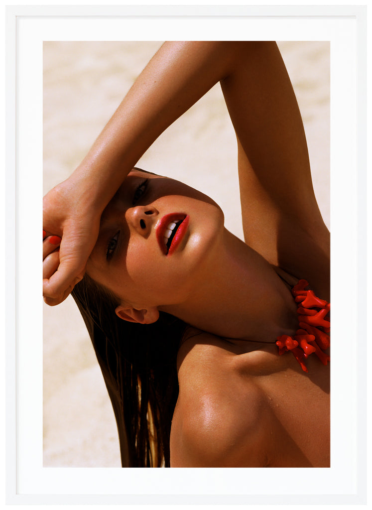 Photograph of a posed wet woman with red lips and top.  White frame. 