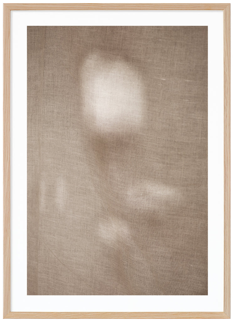 Photographic art of fabric moving in the wind with a beautiful play of light that appears in patches. Oak frame. 