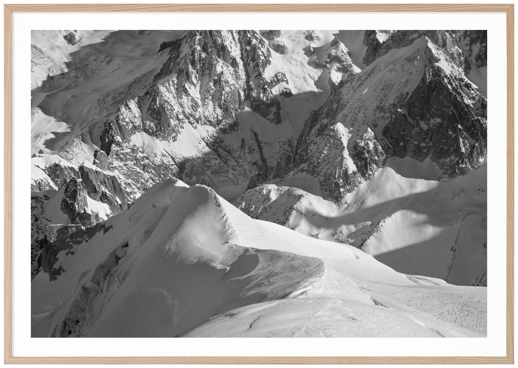 Black and white photograph of snow-capped Alps. Oak frame. 
