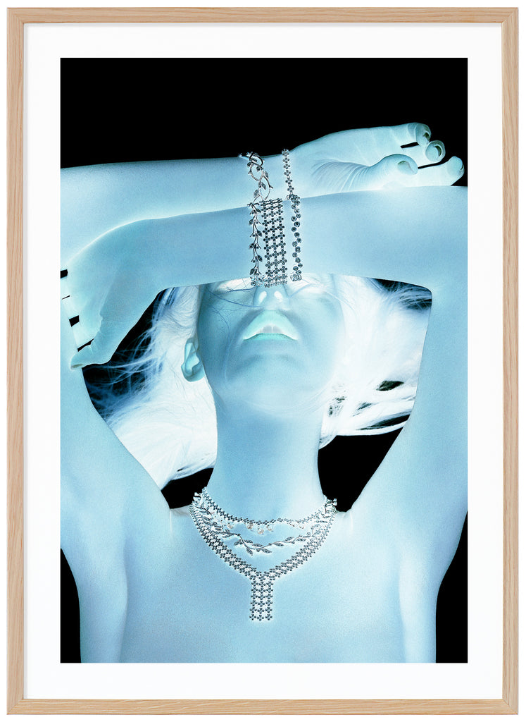 Poster of a woman in light blue glow. Black background. Oak frame. 