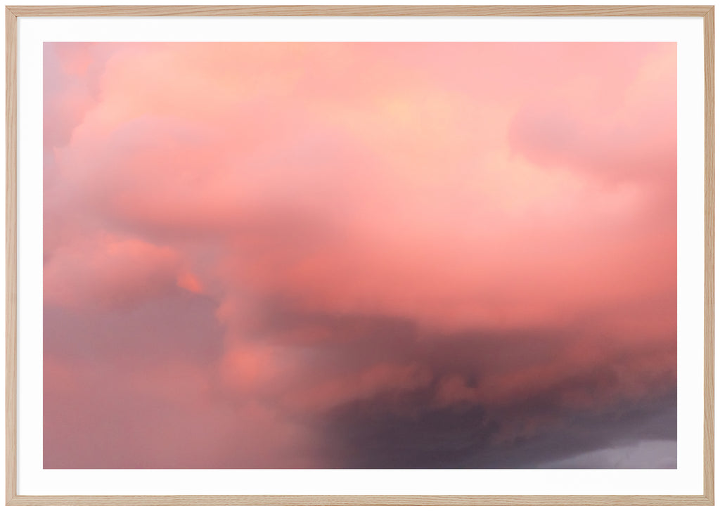 Color photography of clouds in the tones of pink, purple and yellow. Oak frame.