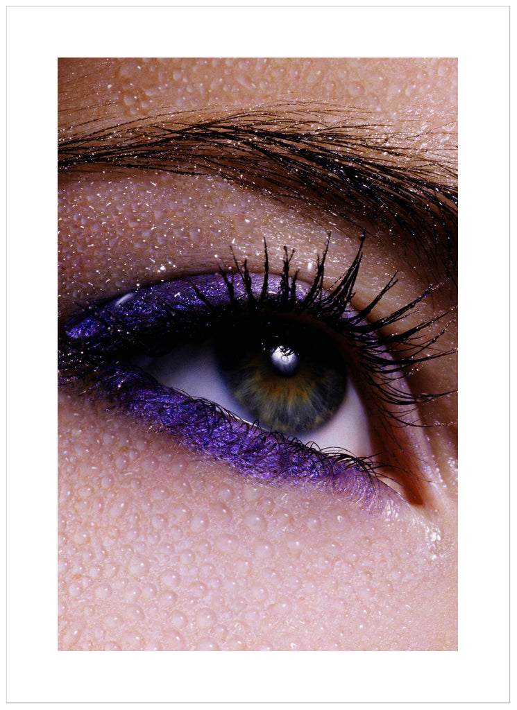 Posts of close-up of eye and eyebrows with purple makeup and water drops over the skin.