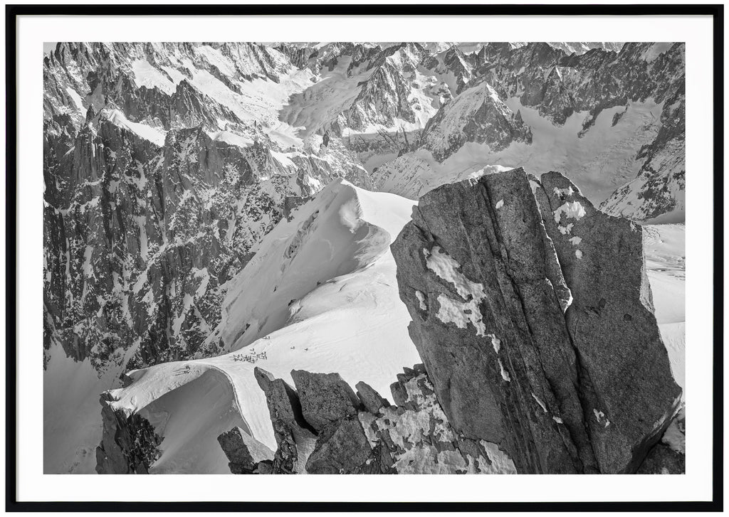 Black and white photograph of cliffs and alps in France. Black frame. 