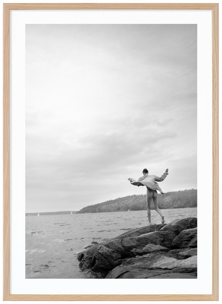 Black and white photograph of a woman on rocks in the archipelago. Oak frame. 