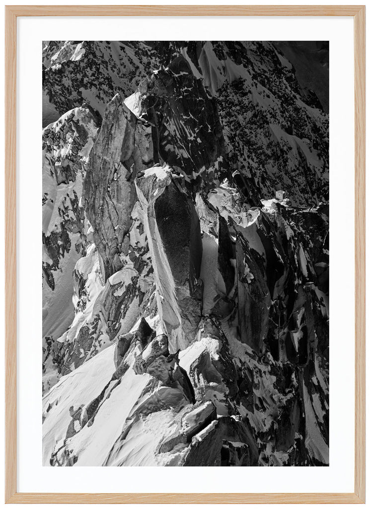 Black and white photograph of sharp cliffs in the Alps. Oak frame. 