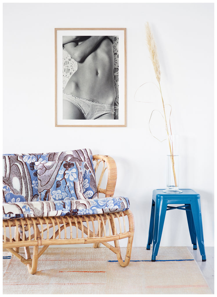 Analogous photograph of a woman lying on her back in panties and embracing her breasts. Oak frame. 