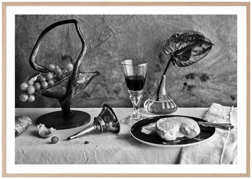  Still life in black and white of a table set with cheese and wine. Oak frame. 