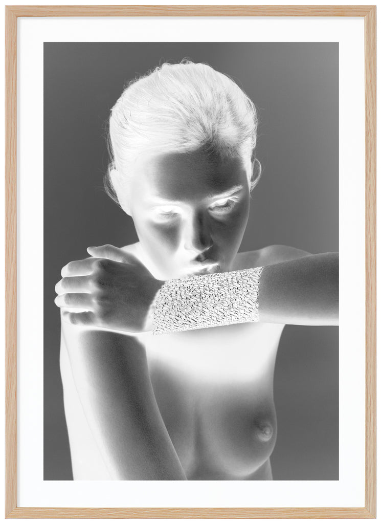  Black and white fashion photography with special effect of a naked woman wearing only an exclusive gold bracelet. Oak frame.