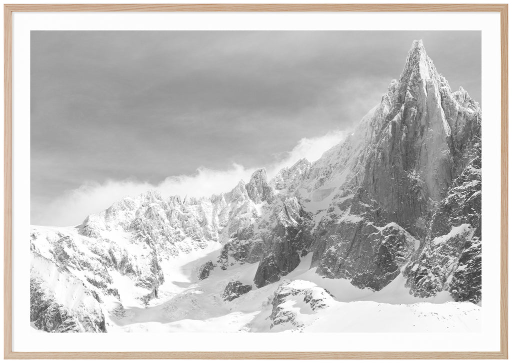 Black and white poster of high mountain with snow. Horizontal format. Oak frame.