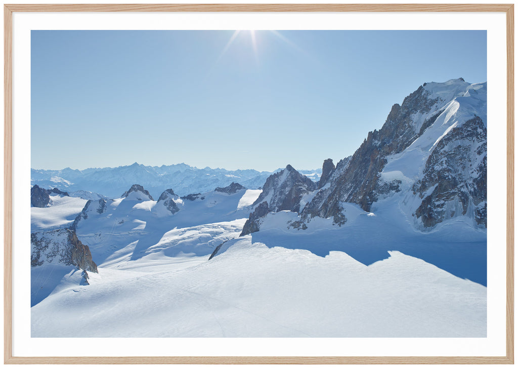 Color photography of snow-capped Alps in panorama. Oak frame. 