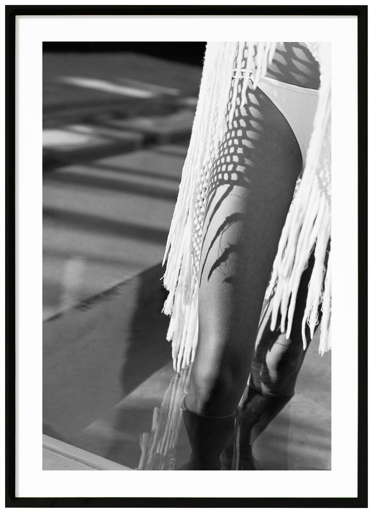 Black and white posters of a woman's legs with bikini. Black frame. 
