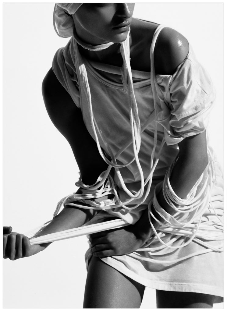Black and white poster of woman with torn clothes.