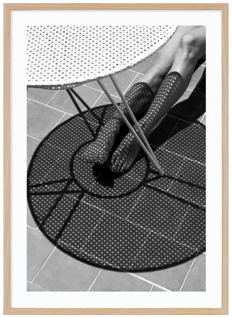 Black and white poster of bone with shadow from table over it. Oak frame. 