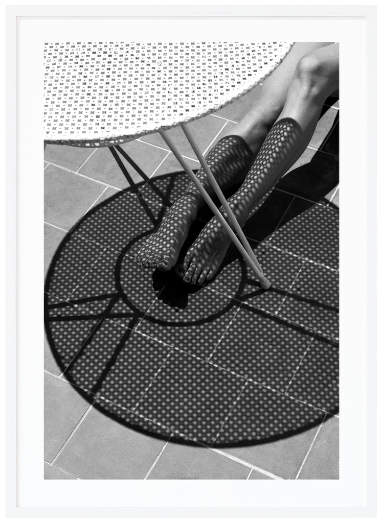 StockingsBlack and white poster of bone with shadow from table over it. White frame. 